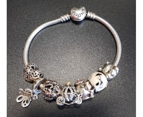 PANDORA MOMENTS HEART CLASP SILVER CHARM BRACELETwith seven Pandora charms including a Disney Cinderella carriage, a Disney B