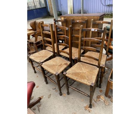 A SET OF SIX ELM AND BEECH LADDER BACK DINING CHAIRS WITH RUSH SEATS