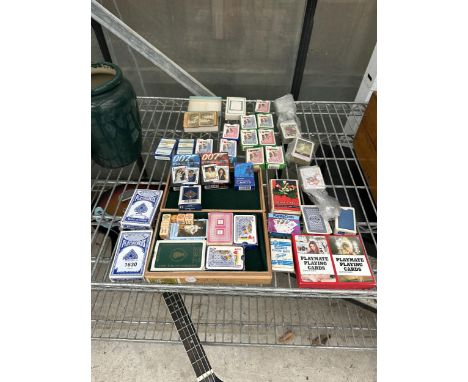 A LARGE QUANTITY OF PLAYING CARD SETS TO INCLUDE JAMES BOND 007, PLAYBOY, ETC