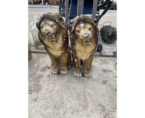 A PAIR OF CERAMIC LION FIGURES
