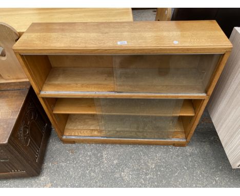 A RETRO LIGHT OAK MINTY LTD (OXFORD) BOOKCASE WITH FOUR GLASS SLIDING DOORS, 35" WIDE