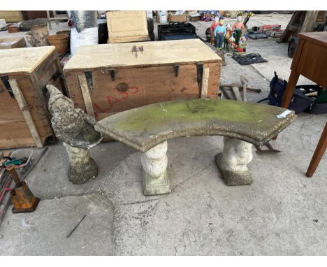 A CONCRETE GARDEN BENCH WITH SQUIRELL PEDESTALS AND A GARDEN GNOME FIGURE