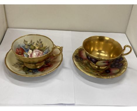 TWO AYNSLEY FOOTED TEACUPS AND SAUCERS TO INCLUDE "CABBAGE ROSE" SIGNED BY J.A. BAILEY AND "ORCHARD GOLD"