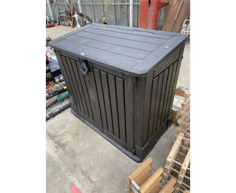 AN OUTDOOR KETTER STORAGE CUPBOARD COMPLETE WITH A FEW GARDEN HAND TOOLS INSIDE
