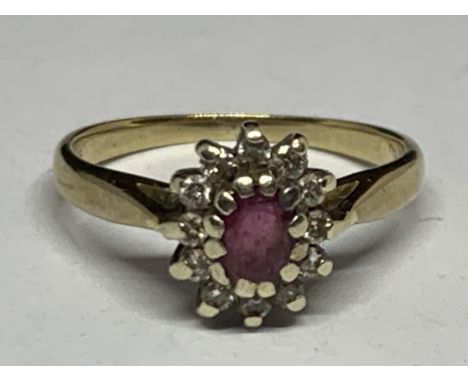 A 9 CARAT GOLD RING WITH CLUSTER DESIGN CENTRE RUBY SURROUNDED BY DIAMONDS SIZE K/L