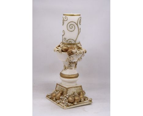 AN ORNATELY DECORATED CANDLE STICK HOLDER WITH FRUIT AND FLOWER DECORATIONS TOGETHER WITH CANDLE, HEIGHT OF HOLDER 28CM