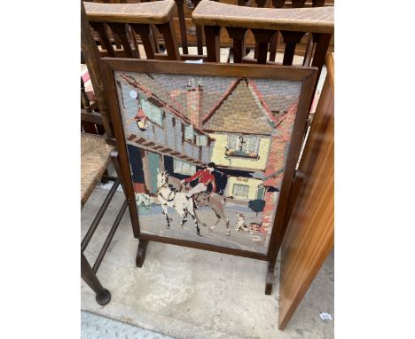 AN EDWARDIAN MAHOGANY SWING FRAME FIRESCREEN WITH WOOLWORK INSET PANEL