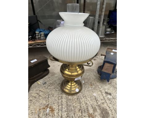 A VINATGE BRASS OIL LAMP WITH GLASS FUNNEL AND WHITE GLASS SHADE