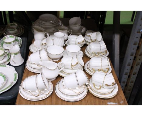 A LARGE QUANTITY OF WHITE WITH GILT HIGHLIGHTS TEA WARE TO INCLUDE ROYAL CROWN DERBY AND DUCHESS PLATES, CUPS, SAUCERS, CREAM