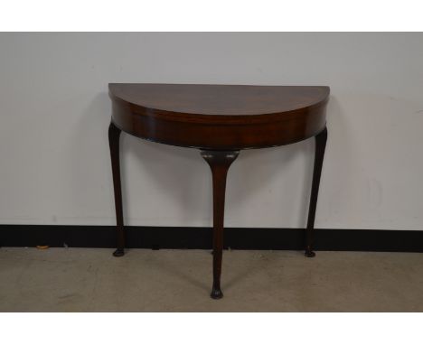 A late Victorian walnut and mahogany demi lune card table, replacement green base, fold open top with pull out rear leg, rais