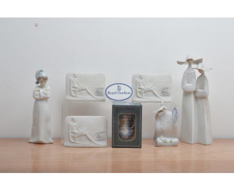 An assorted collection of Lladro ceramics, comprising four advertising plaques (three bisque), together with two figurines, a