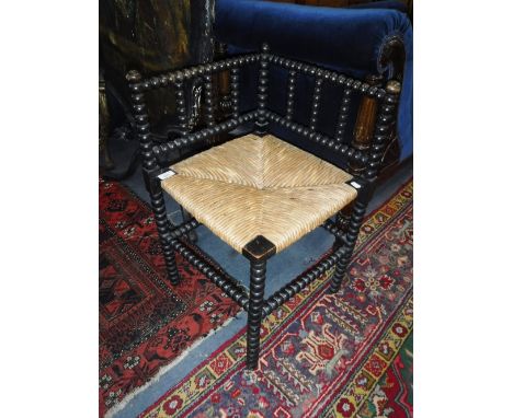 A VICTORIAN BOBBIN-TURNED CORNER CHAIR with rush seat