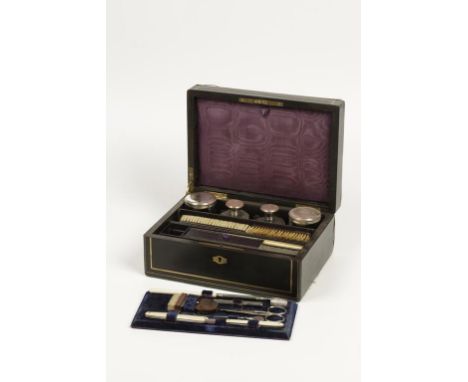 A 19TH CENTURY FRENCH EBONISED AND BRASS INLAID WORKBOX containing a quantity of manicure tools and similar items