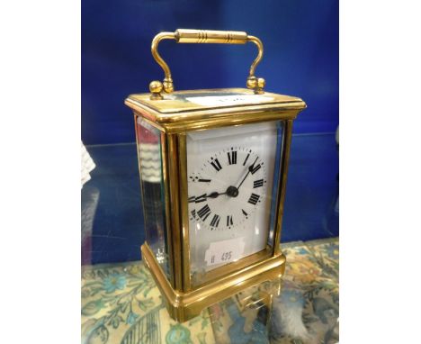 A FRENCH BRASS-CASED CARRIAGE CLOCK with white enamel dial