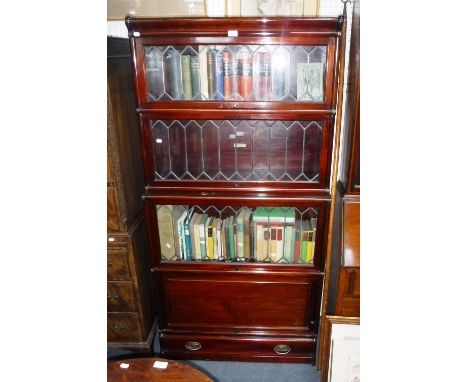 THE GLOBE-WERNICKE CO LTD: A four section mahogany bookcase, with leaded glazed doors, 34" wide