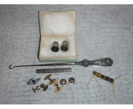 A SILVER HANDLED BUTTON HOOK, two thimbles and other small items