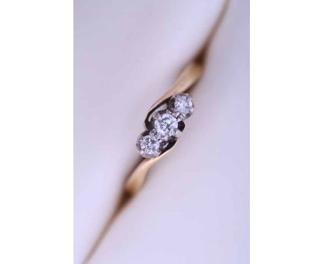 DIAMOND THREE STONE RING
with three graduated brilliant cut diamonds, in nine carat gold, size R