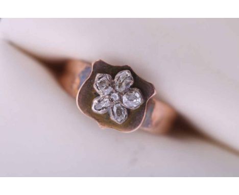 UNUSUAL VICTORIAN DIAMOND RING
with a shield shaped bezel set a floral cluster of old cut diamonds, hallmarked nine carat gol