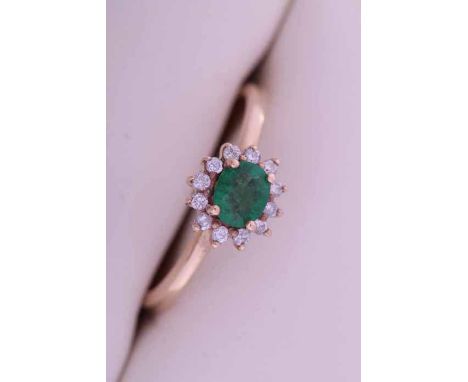 EMERALD AND DIAMOND CLUSTER RING
the central oval cut emerald very approximately 0.35 carats, surrounded by brilliant cut dia