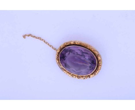 AMETHYST AND PEARL BROOCH
with a large oval amethyst measuring 19mm x 14mm, in scrolling border, in nine carat gold