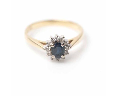 SAPPHIRE AND DIAMOND CLUSTER RING
set centrally with an oval sapphire, surrounded by a cluster of brilliant cut diamonds, in 