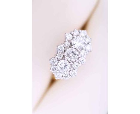 IMPRESSIVE DIAMOND CLUSTER RING
set with a row of three central brilliant cut diamonds totalling approximately 0.8 carats, su