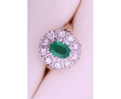 EMERALD AND DIAMOND CLUSTER RING
the central oval cut emerald approximately 0.93 carats, surrounded by brilliant cut diamonds