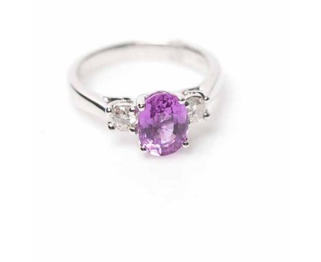 PINK SAPPHIRE AND DIAMOND THREE STONE RING
set centrally with an oval pink sapphire approximately 2.27 carats, flanked by two