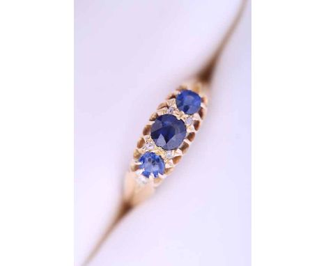 VICTORIAN SAPPHIRE THREE STONE RING
set with three oval cut sapphires interspersed with diamonds, hallmarked for eighteen car