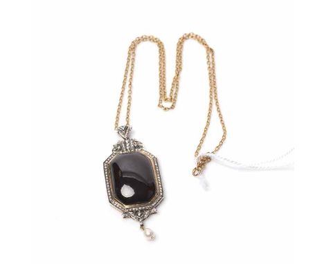 GARNET AND DIAMOND PENDANT ON CHAIN
set with a rounded rectangular cabochon garnet,  within a surround of round diamonds, unm
