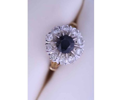 SAPPHIRE AND DIAMOND CLUSTER RING
the central round sapphire approximately 1.42 carats, surrounded by brilliant cut diamonds,