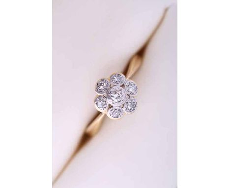 DIAMOND CLUSTER RING
of flower form, illusion set with brilliant cut diamonds, in eighteen carat gold and platinum, size M-N