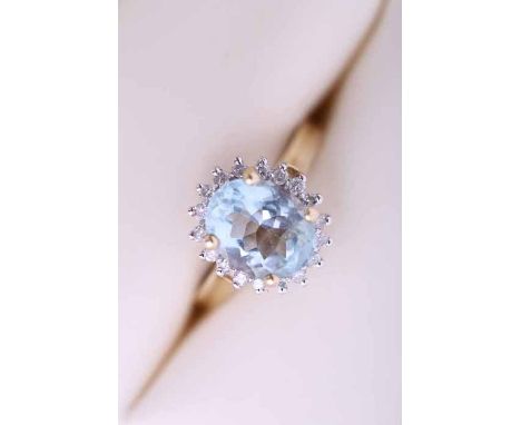 AQUAMARINE AND DIAMOND CLUSTER RING
the large central oval cut aquamarine approximately 2.5 carats, surrounded by a row of br