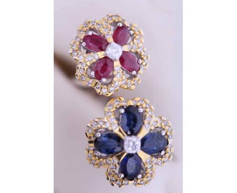 UNUSUAL SAPPHIRE, RUBY AND DIAMOND CLUSTER RING
with four oval rubies totalling approximately 1.40 carats, four oval sapphire