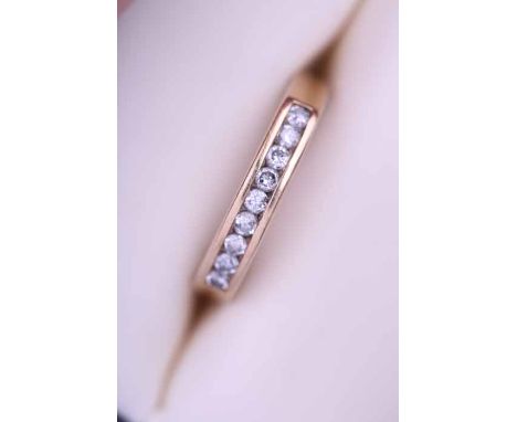 DIAMOND HALF ETERNITY RING
channel set with a row of brilliant cut diamonds, in nine carat gold, size R