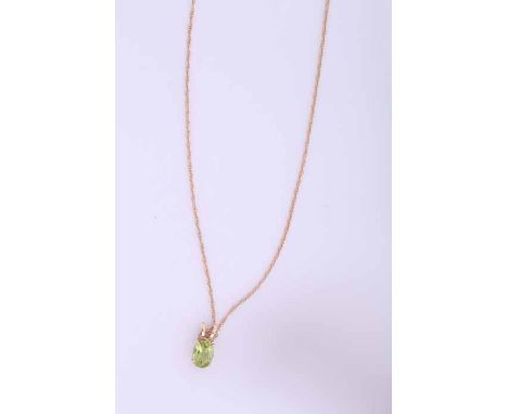 FOURTEEN CARAT GOLD PERIDOT PENDANT
set with an oval peridot measuring approximately 7mm x 5mm, in fourteen carat setting, on