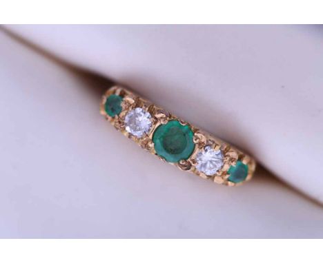 EMERALD AND DIAMOND FIVE STONE RING
set with three emeralds spaced by two diamonds, in eighteen carat gold, size K