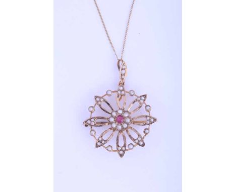 RUBY AND SEED PEARL HOLBEIN
of floral design, with a central round ruby surrounded by seed pearls, marked 9ct for nine carat 