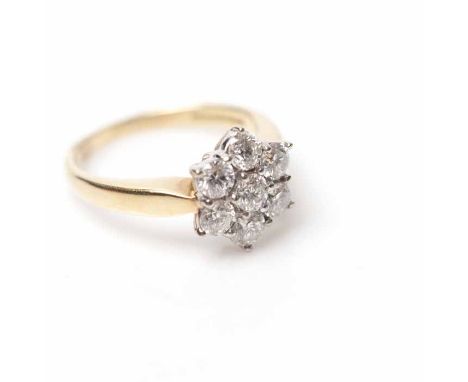 DIAMOND CLUSTER RING
with a flower shaped cluster of brilliant cut diamonds totalling approximately 0.7 carats, in eighteen c