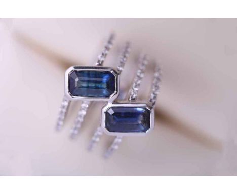 SAPPHIRE AND DIAMOND DRESS RING
set with two emerald cut sapphires, each measuring 7.48mm x 4.64mm, formed of four bands, eac