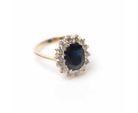 SAPPHIRE AND DIAMOND CLUSTER RING
the central oval cut sapphire approximately 3.08 carats, surrounded by brilliant cut diamon