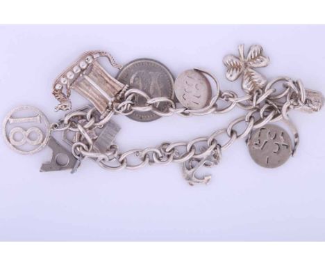 STERLING SILVER CHARM BRACELET
with charms including a coin, an anchor, a clover, etc; together with a collection of loose ch
