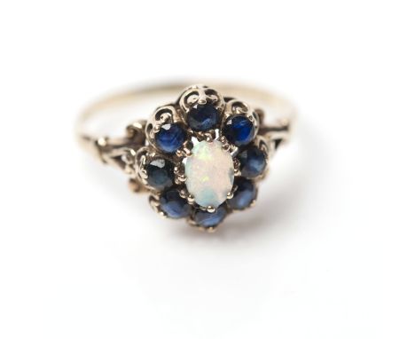 OPAL AND SAPPHIRE CLUSTER RING
with a central oval opal, surrounded by sapphires, in nine carat gold, size M-N