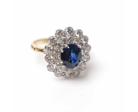 IMPRESSIVE SAPPHIRE AND DIAMOND CLUSTER RING
the oval sapphire approximately 2.53 carats, surrounded by two rows of brilliant