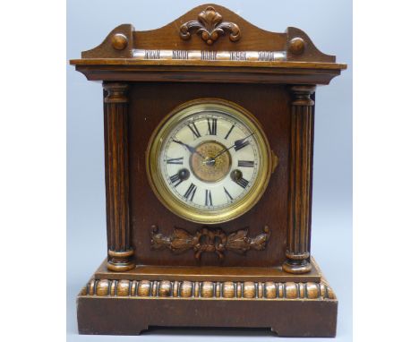 Late Victorian oak mantle clock with circular dial, twin train German HAC movement striking the half hours on a coil, H35cm  