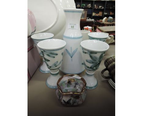 A ceramic decanter and goblet set with hand decorated glaze