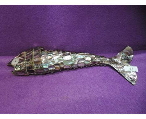 An articulated figure of a fish with copper and brass fitments and mother of pearl scales