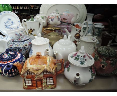 A selection of ceramic tea and coffee pots including Ringtons and hand decorated