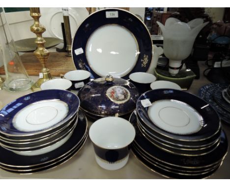 A part tea service by Epaig with deep blue and gilt glaze
