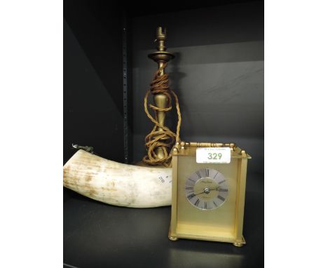 An early 20th century brass bodied lamp with horn and carriage clock